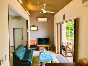 a living room with a couch and a table at Beach Villa Tachibana in Onomichi