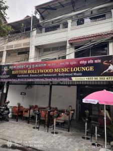 a sign for a music lounge in front of a building at Rhythm Bollywood Guesthouse in Phnom Penh