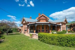 a large brick house with a green yard at Luxury at Lauralla - An Elegant Victorian Escape in Mudgee