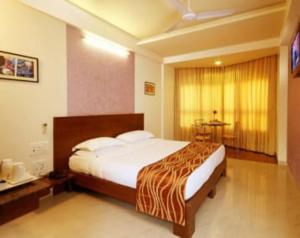 a bedroom with a large bed in a room at Hotel Bhagyalaxmi , Shirdi in Shirdi