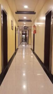 a hallway of a building with a long corridor at Hotel Bhagyalaxmi , Shirdi in Shirdi