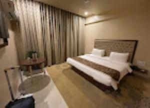 a hotel room with a bed and a window at Hotel Bhagyalaxmi , Shirdi in Shirdi