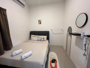 ein kleines Zimmer mit einem Bett und einem Spiegel in der Unterkunft FunkyVila4 14PAX 4BR Near188Tower, ArtStreet, HTTA in Kuantan