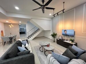 a living room with a couch and a tv at FunkyVila4 14PAX 4BR Near188Tower, ArtStreet, HTTA in Kuantan