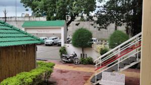 un parcheggio con una moto parcheggiata di fronte a un garage di Hotel Rasraj , Dhule a Dhule