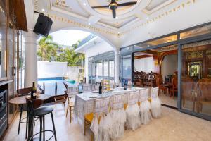a dining room with a long table and chairs at B2.20 Hoàng Sơn in Vung Tau