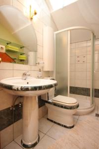 a bathroom with a sink and a toilet and a shower at Apartments by the sea Split - 7602 in Split