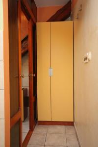 an empty room with a yellow cabinet in a room at Apartments by the sea Split - 7602 in Split
