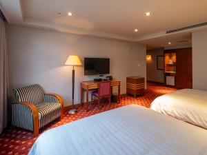 Rúm í herbergi á Rich & Free Hotel - Fuzhong 富逸旅趣-板橋府中館