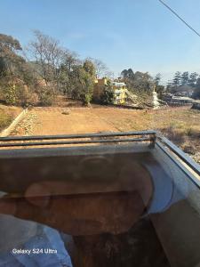 a view from the front window of a vehicle at Pharping Homestay in Dakshīnkāli +3 photos