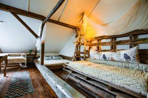 a bedroom with a bed in a tent at Tatra Magic in Malužiná