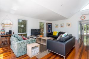a living room with two couches and a tv at Stroll to the Sea - Sun-drenched Seaside Lifestyle in Rye