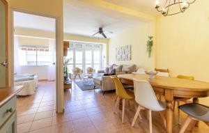 a dining room and living room with a table and chairs at Awesome Apartment In Santiago De La Ribera With Kitchen in Santiago de la Ribera