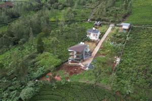 an aerial view of a house on a farm at OOTYHOMZ LUXURY STAY in Ooty
