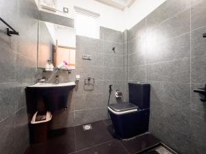 a bathroom with a toilet and a sink at The Mount View Single Tree Hotel in Nuwara Eliya