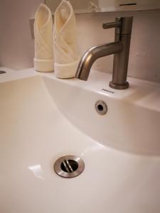 a sink with a faucet and some white towels at Urban Boutique Hotel in Boracay
