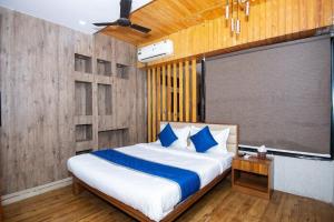 a bedroom with a bed and a large screen at Hotel Global in Bhatha