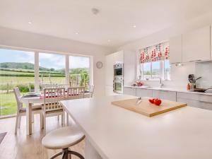 a kitchen with a white counter top and a table at 3 Bed in Hay on Wye 77381 in Hay-on-Wye