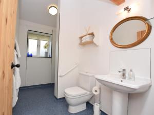 a bathroom with a toilet and a sink and a mirror at 1 Bed in Hilton 76518 in Tutbury