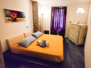a bedroom with a bed with a teddy bear on it at [Casa Glicine] Centro Storico in Pinerolo