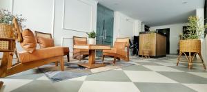 a living room with furniture on a checkered floor at Irroi Guwahati in Guwahati