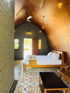 a bedroom with a bed and a table in a room at Historic Heaven wayanad in Vythiri