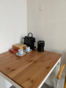 a wooden table with two cups on top of it at Bluestone Appartments - 26qm free and near parking in Blaustein