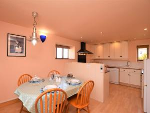 a kitchen and dining room with a table and chairs at 2 Bed in Godshill IC129 in Godshill