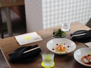 a wooden table with plates of food on it at Ardo in Townsville