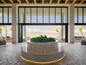 a lobby with a fountain in the middle of a building at Ardo in Townsville