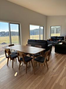 a living room with a wooden table and chairs at Ocean Yakka, Kangaroo Island in Penneshaw