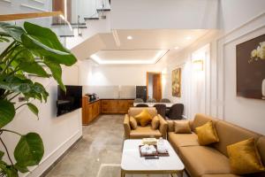 a living room with a couch and a table at La Fleur Premium Central Apartment Hotel in Da Lat