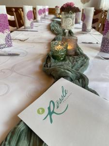 a long table with candles and a sign on it at Gasthof Rössle Eberhardzell in Füramoos