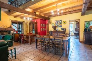 a kitchen and dining room with a table and chairs at La Ferme de Leychoisier in Bonnac-la-Côte