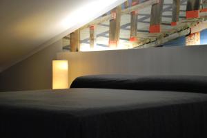a bedroom with a bed and a stair case at Aparthotel Meseguer in Alcañiz