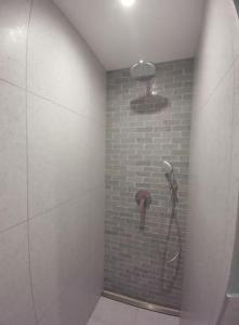 a bathroom with a shower with a phone on the wall at Villa Cocoon Contis océan à 900m in Lit-et-Mixe +18 photos