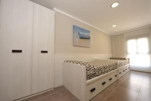 a bedroom with a bed with a built in cabinet at Aparthotel Meseguer in Alcañiz