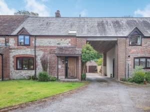 a brick house with a garage and a driveway at 3 Bed in Winfrith Newburgh DC108 in Winfrith Newburgh