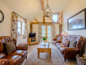 a living room with leather couches and a coffee table at 2 Bed in Ironbridge 77771 in Leighton