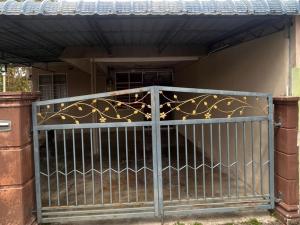 a metal gate in front of a house at SUFIZA Residence in Kangar