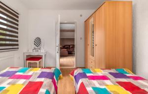 a bedroom with a bed and a closet and a cabinet at Apartments Sweet Home in Otočac