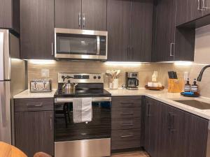 a kitchen with a stove and a microwave at Luxury 1BDR centrally located in Hollywood in Los Angeles