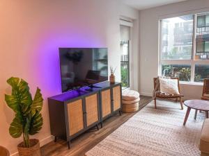 a living room with a large flat screen tv at Luxury 1BDR centrally located in Hollywood in Los Angeles