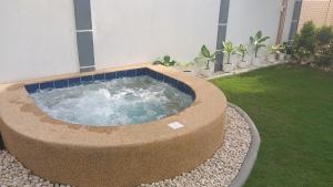 a hot tub in a garden in a backyard at UB HOME in Dauis