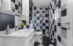 a bathroom with a white sink and a toilet at Apartments Sweet Home in Otočac +47 photos