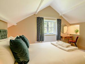 a bedroom with a large white bed with green pillows at 3 Bed in Leominster 93304 in Bodenham