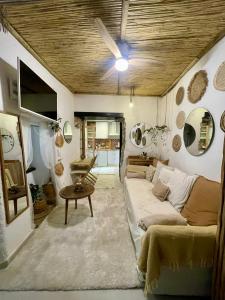 a living room with a couch and a ceiling fan at Arcos de Tarifa, Casco historico in Tarifa