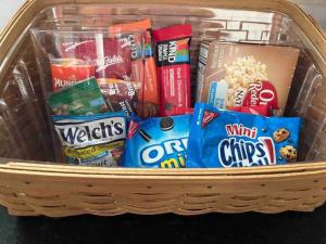 a basket filled with different types of food and snacks at Blue Moon Cottage - Music Room, Inground Pool in Owensboro