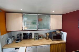 a kitchen with a counter top with a microwave at Tranquillité ,vue mer in Chiatra