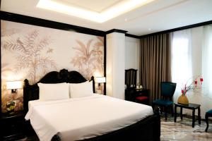 a bedroom with a large white bed in a room at Nicecy Saigon Hotel in Ho Chi Minh City